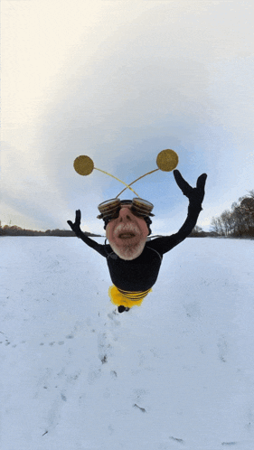 a man in a bee costume is falling through the air