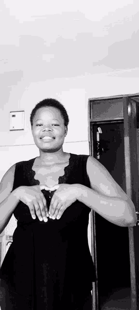 a black and white photo of a woman in a black tank top