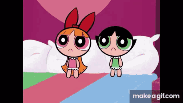two cartoon girls are sitting on a bed with a heart in the background .