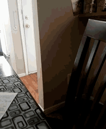 a corner of a room with a door and a table
