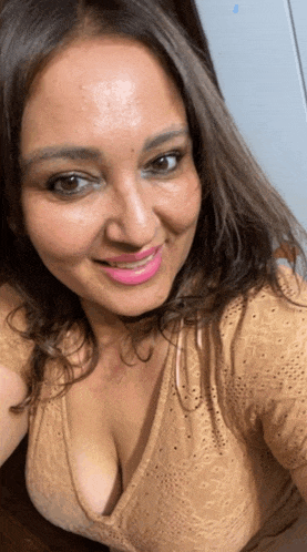 a woman with a very plunging neckline is smiling for the camera