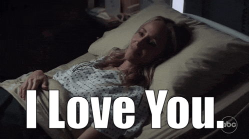 a woman in a hospital bed with the words i love you