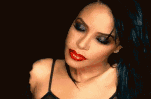 a close up of a woman with red lipstick
