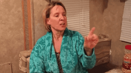 a woman in a bathrobe says " you are a piece of shit " in white letters