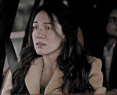 a woman sitting in a car with a seat belt on