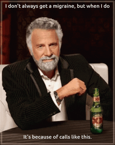 a man with a beard is sitting at a table with a bottle of del monte beer