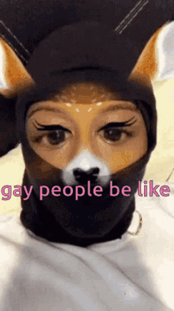a person wearing a cat mask with the words gay people be like on it