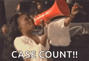 a woman is holding a megaphone in her hand and shouting into it .