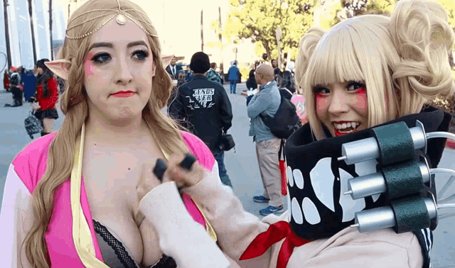 a woman wearing a hoodie that says " candy girl " stands next to another woman