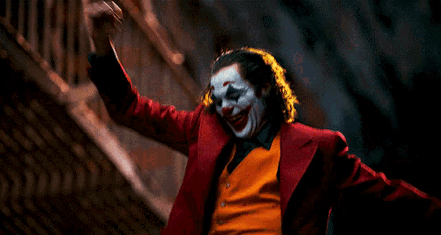 a man in a clown costume with his arms outstretched