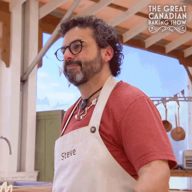 a man wearing a white apron with the name steve written on it