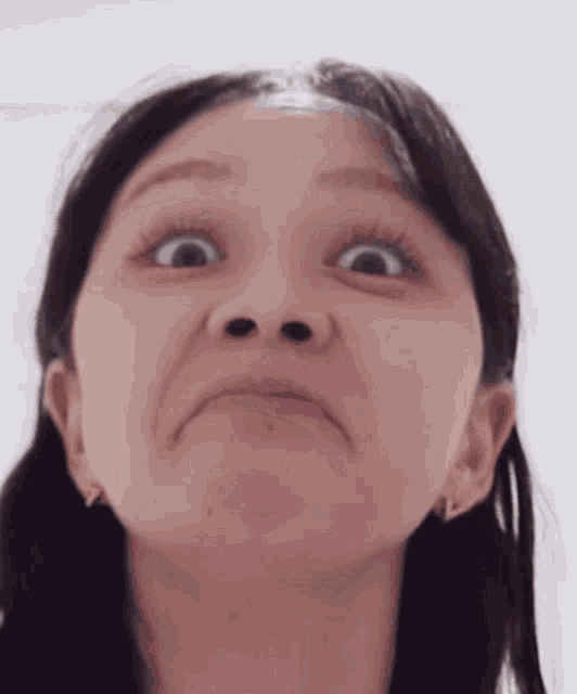 a woman is making a funny face with her mouth open .