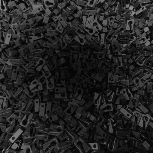 a pile of black bricks with the word pow on the bottom right