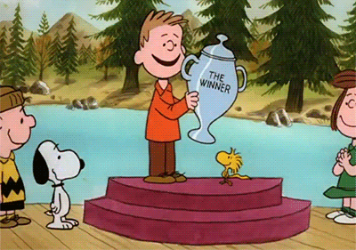 a cartoon of a boy holding a trophy that says " the winner "