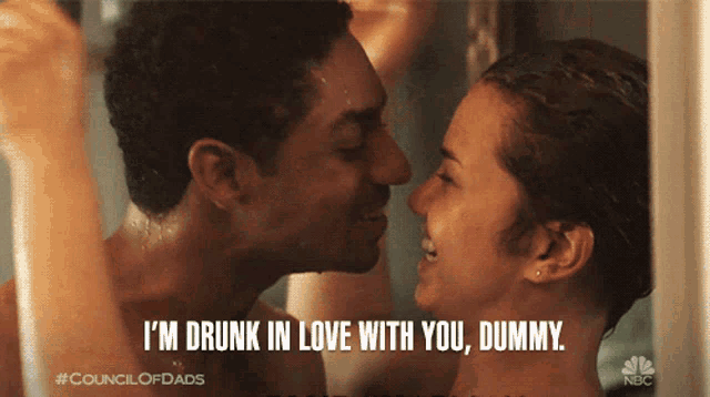 a man and a woman are kissing in a shower and the caption says i 'm drunk in love with you dummy