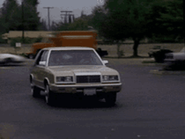 a car with a license plate that says ' a ' on it is driving down a street