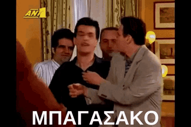 a group of men are standing next to each other in a living room and talking .