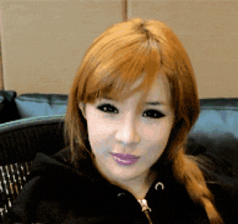 a close up of a woman 's face with red hair