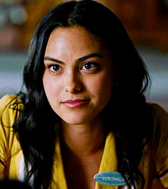 a close up of a woman 's face with a name tag that says veronica