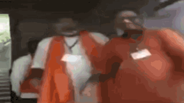 a blurry picture of a man in an orange shirt