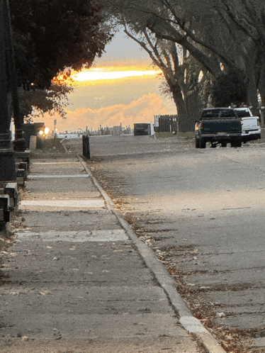 a black truck is parked on the side of a road