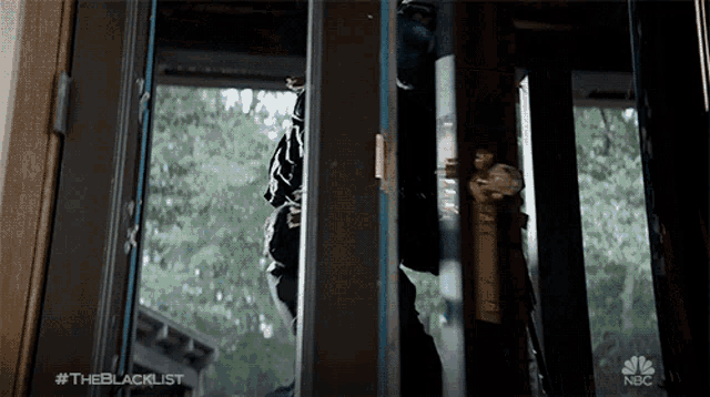 a nbc advertisement for the blacklist shows a man standing in a doorway