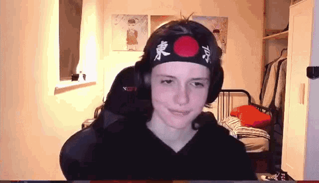 a young man wearing a headband that says tokyo
