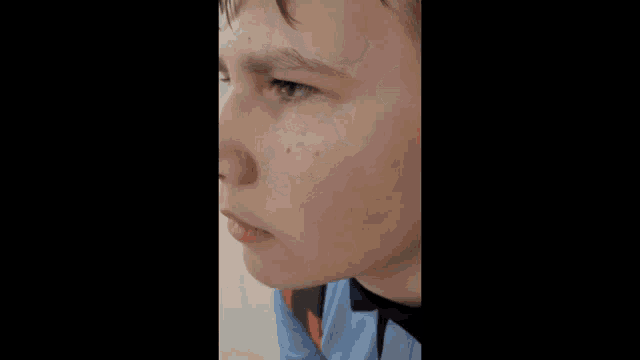 a close up of a person 's face with a black spot on his nose