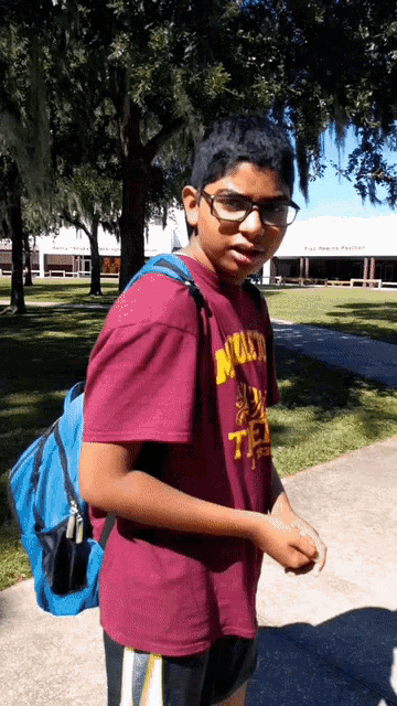 a boy wearing a t-shirt that says nuern on it