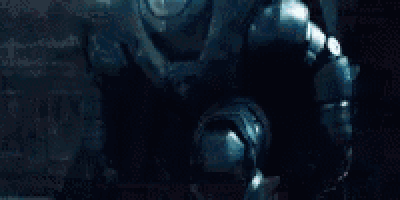 a man in a superhero costume is running through a building .