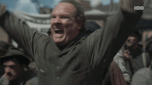 a man is screaming with his arms in the air in front of a crowd with hbo written on the bottom of the screen