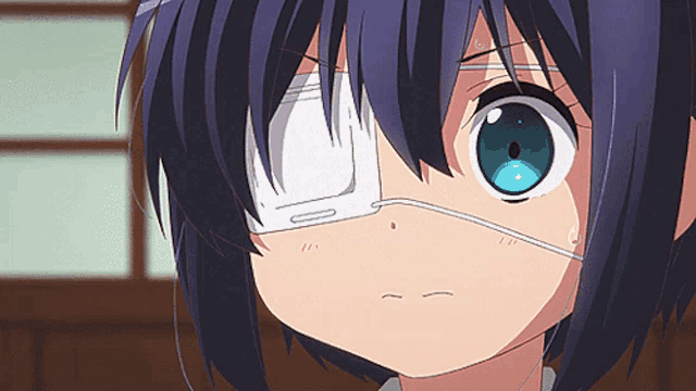 a girl with a bandage on her eye looks angry