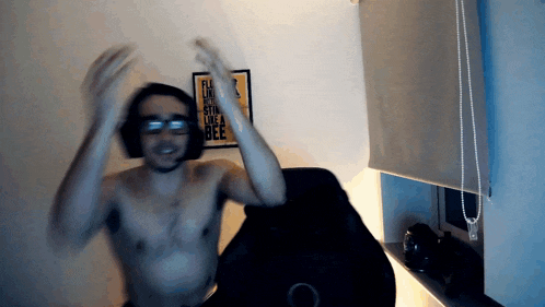 a man without a shirt is dancing in front of a poster that says " i like a bee "