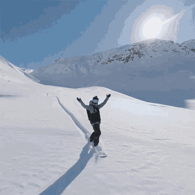 a person riding a snowboard on a snowy mountain