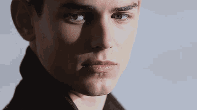 a close up of a man 's face with a shadow on it