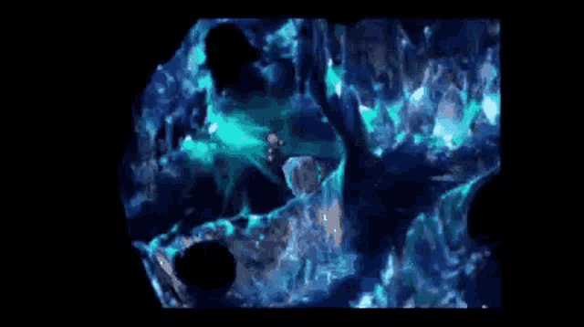 a person is standing in a cave with a lot of ice and a blue light coming out of it .