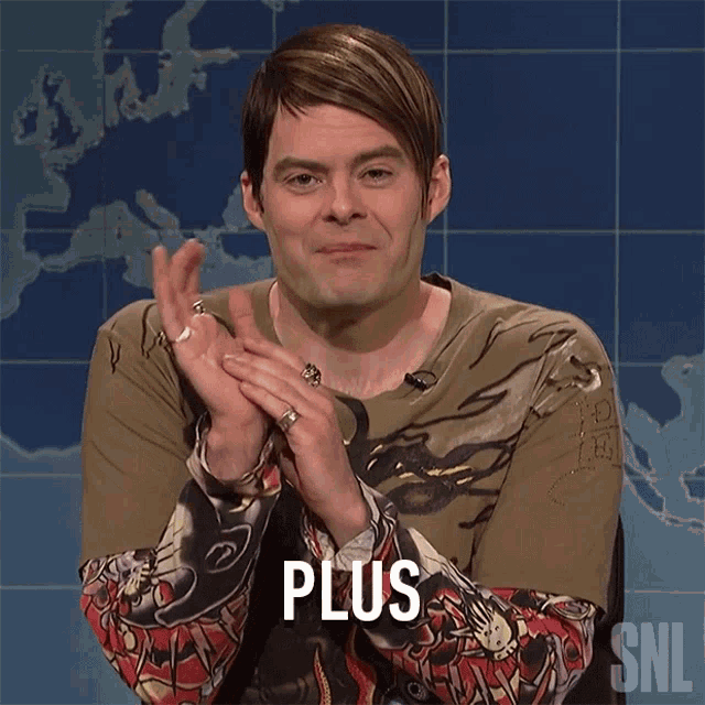a man in a snl shirt applauds with the word plus on his chest