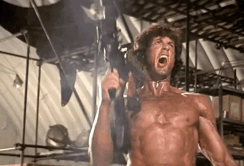 a shirtless man is holding a gun with his mouth open and screaming .