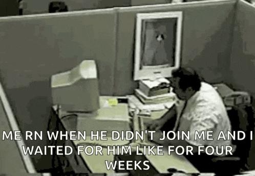 a man is sitting at a desk in front of a computer and waiting for him like for four weeks .