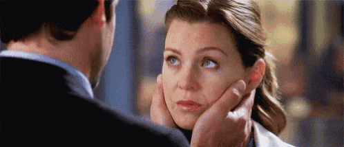a man is touching a woman 's face .