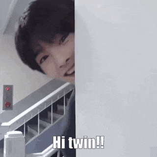 a man is peeking out from behind a wall and says hi twin !