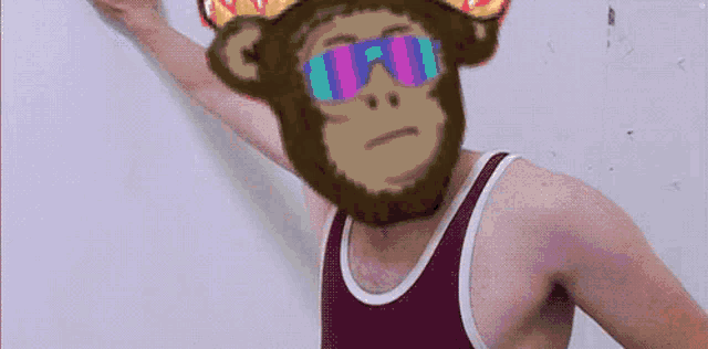 a man wearing a tank top with a monkey on his head