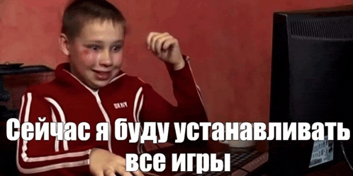 a boy in a red jacket is playing a video game on a computer ..