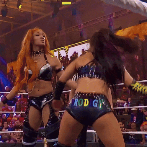 a woman in a wrestling ring has rod gy painted on the back of her shorts
