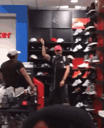 a man in a red hat is dancing in a shoe store .