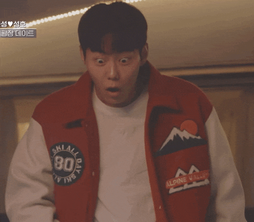 a man is wearing a red jacket that says ski all day 80