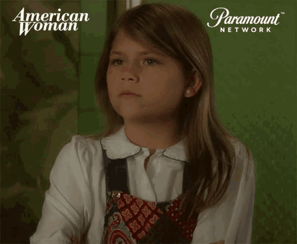 a young girl is sitting in front of a paramount network ad