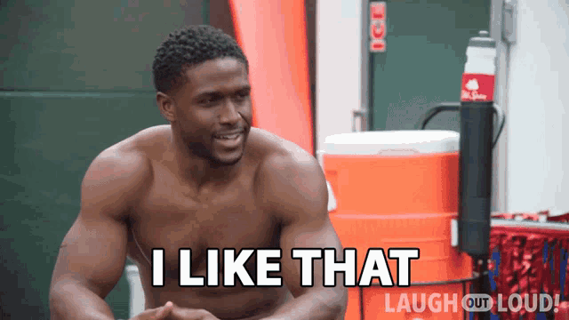 a shirtless man says " i like that " in front of a cooler