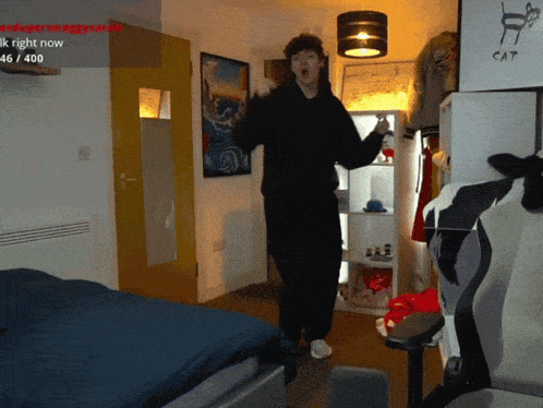 a man is dancing in a room with a sign that says ' ik right now '
