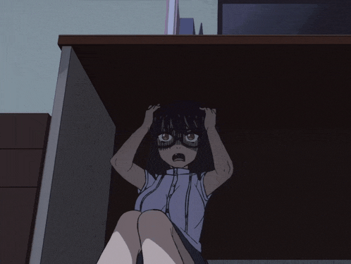 a girl sitting under a table with her hands on her head